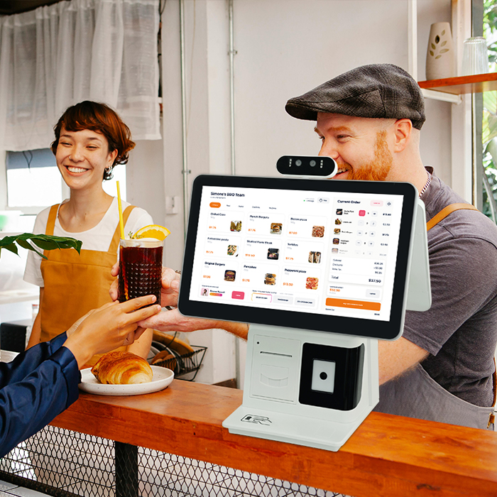 Dual-screen all-in-one POS register at a restaurant counter, running a restaurant menu